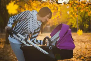 woman looking at her baby in stroller