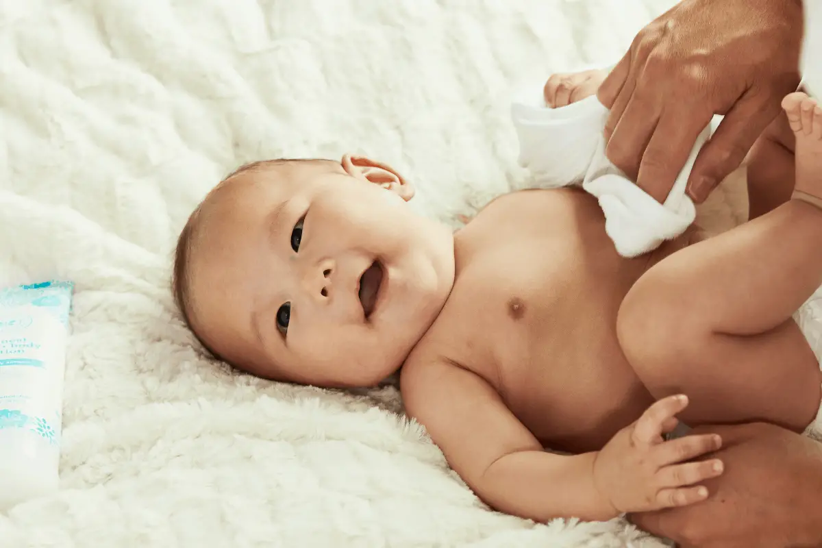 Baby lying on a white mat