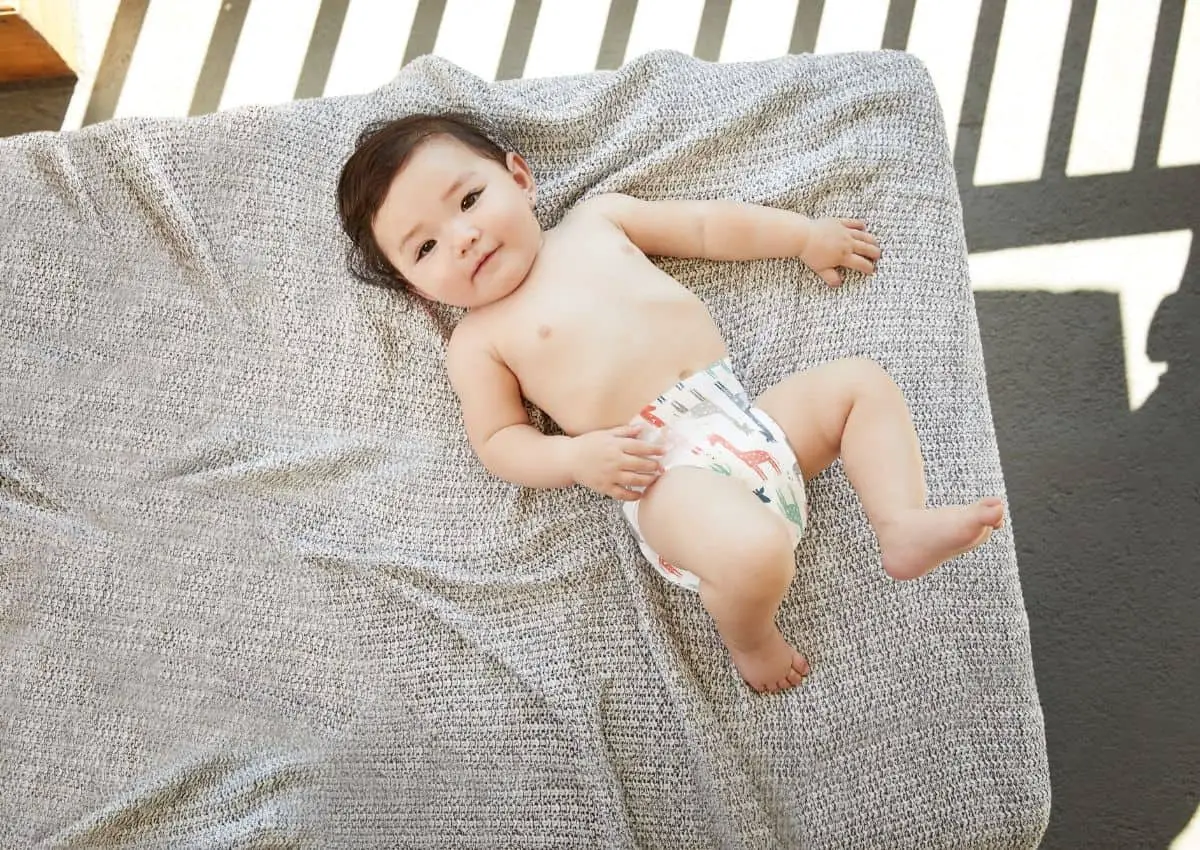 Baby In a Diaper on Grey Bed