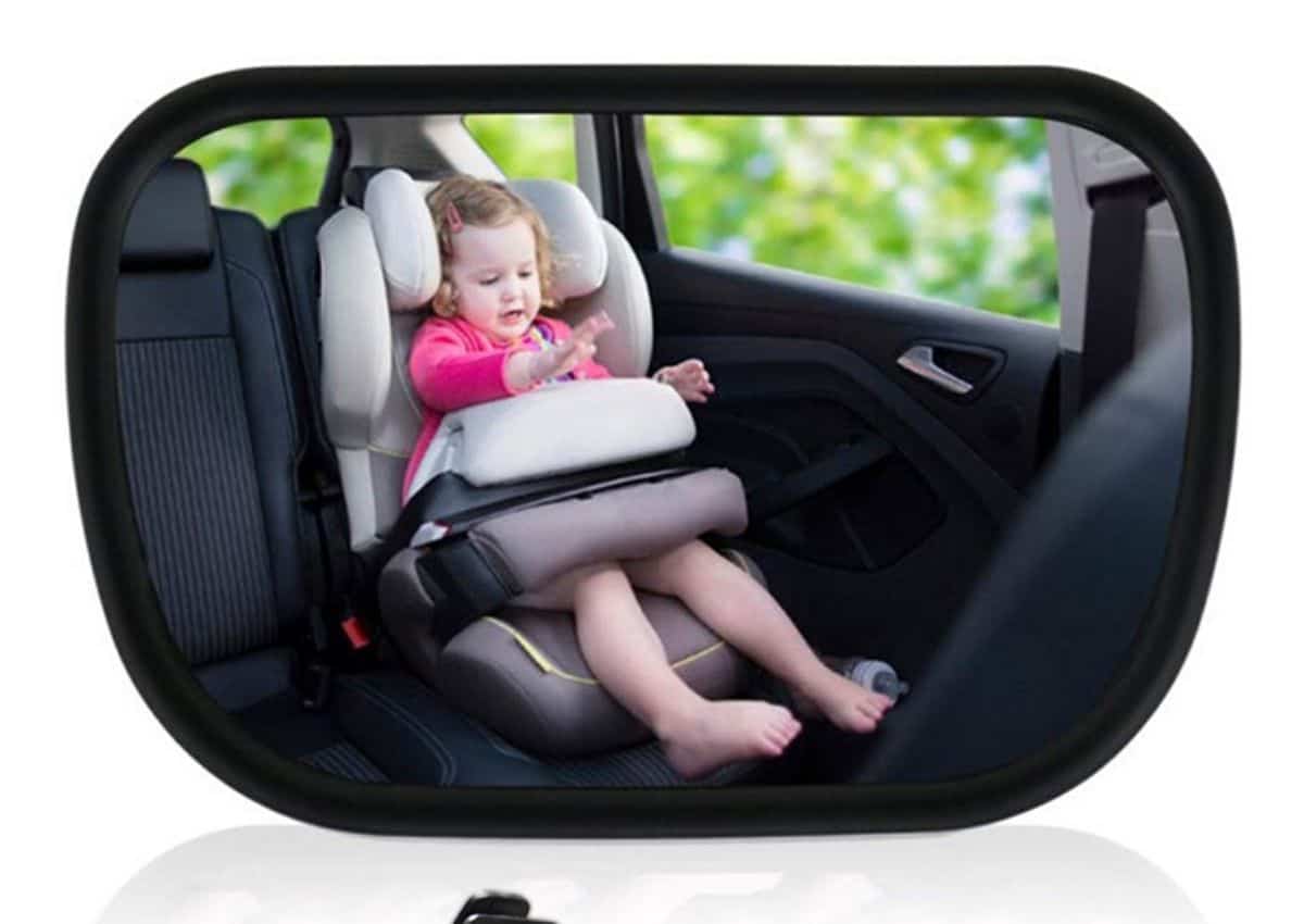 baby in a rearview car mirror