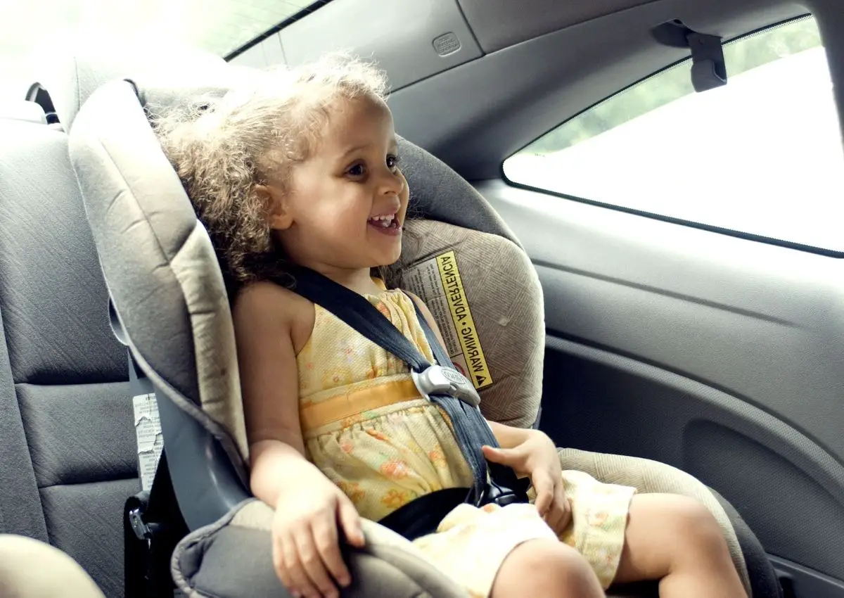 young girl sitting in a car seat