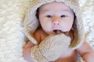 baby wearing mittens