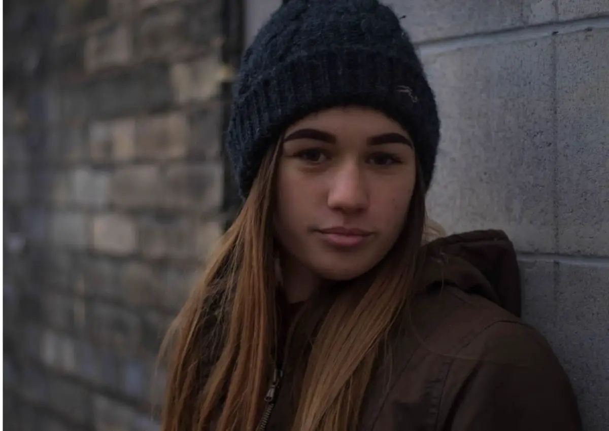 young girl wearing a black beanie