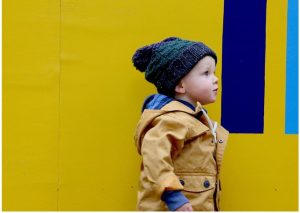 baby boy wearing a yellow coat