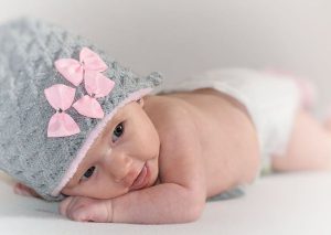 Newborn baby wearing a grey knitted cap