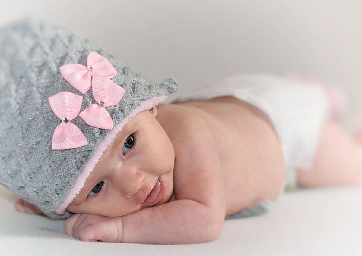 Newborn baby wearing a grey knitted cap