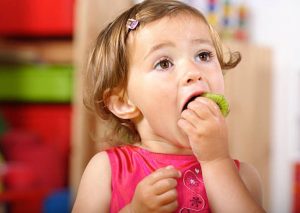 baby eating kiwifruit